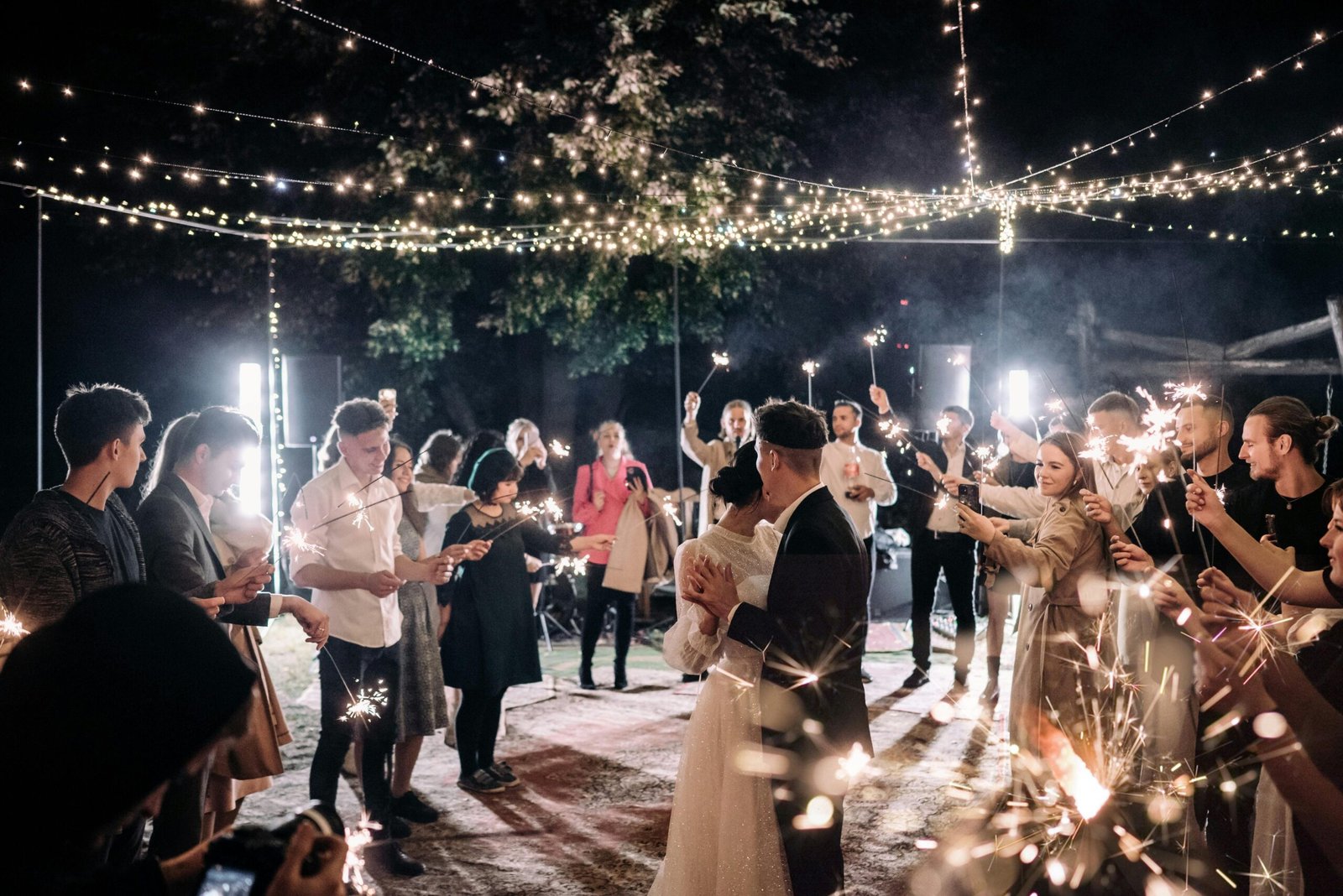 A vibrant wedding dance floor filled with joyous guests celebrating to upbeat music.